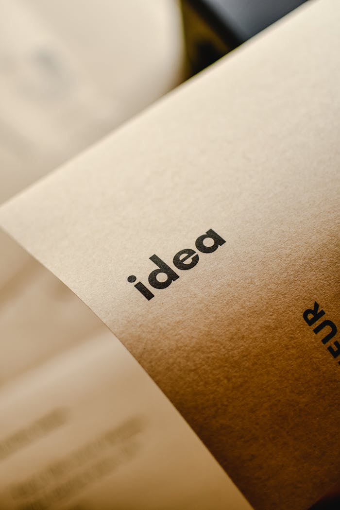 gallery-02 Close-up shot of the word 'idea' printed on brown paper, perfect for representing creativity and startups.